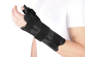 A black elastic bandage on someone's wrist. 