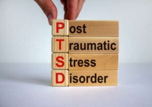 Small wooden blocks stacked on top of each other to spell out "Post-Traumatic Stress Disorder"