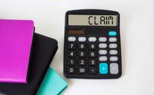 A calculator with the word 'claim' shown on the screen.