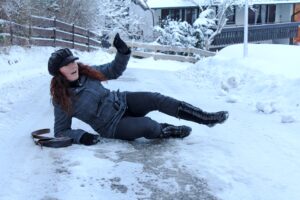 A woman slips on a icy street