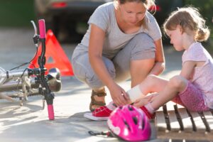 An injured child has her leg bandaged. 