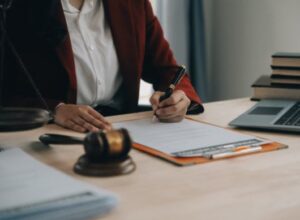 A criminal injury solicitor sat at a desk and filling out a form