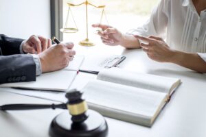 Two solicitors at a desk discussing their client's scaffolding accident claim