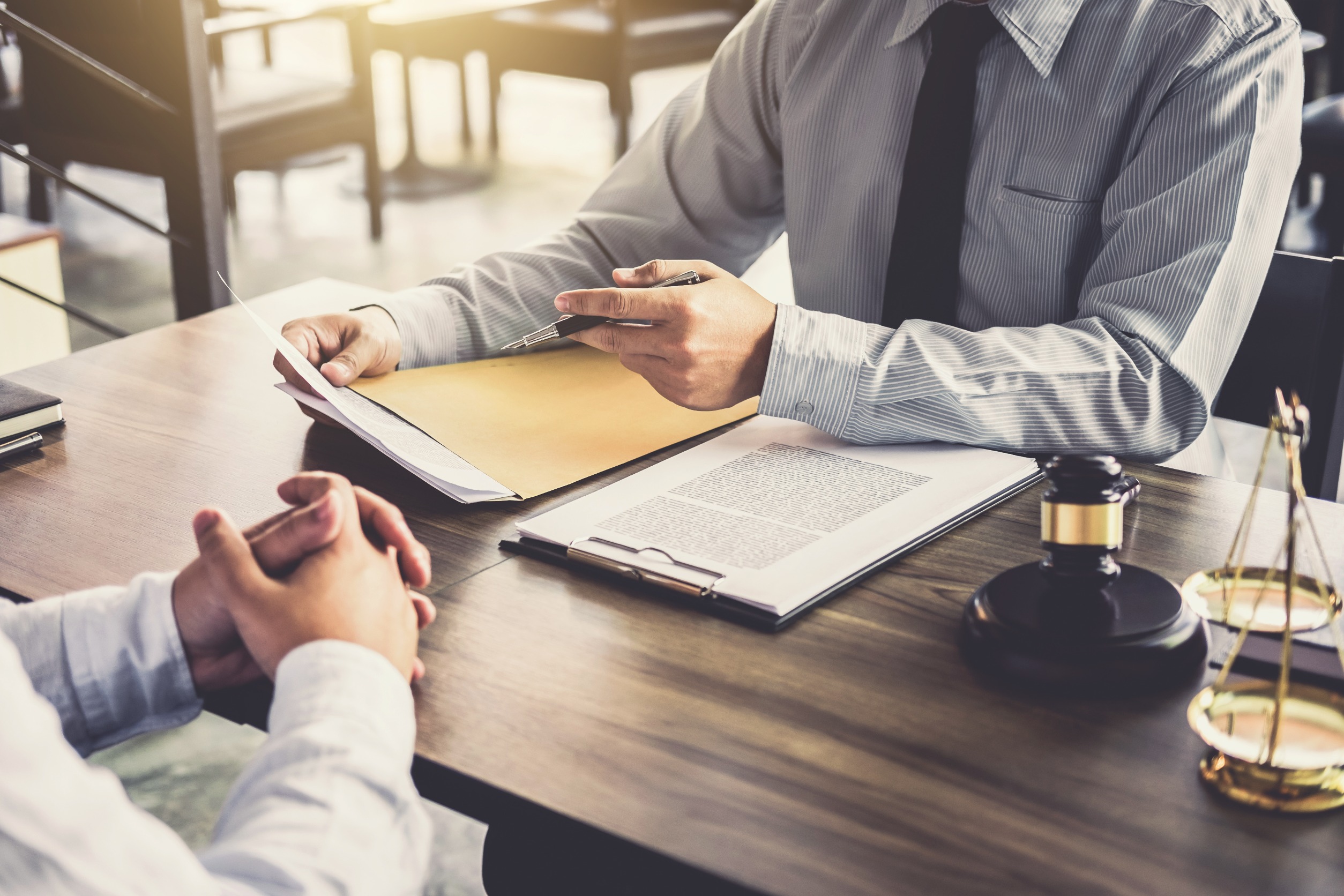 A solicitor works on a broken leg at work claim with a client.