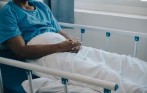 A patient sat in a hospital bed.