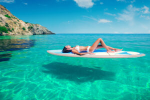 PERSON ON A LILO IN A LAGOON ON HOLIDAY ABROAD