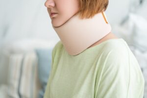 PERSON WITH NECK BRACE AFTER AN ACCIDENT ABROAD