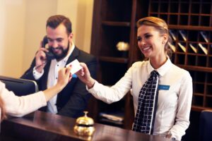 hotel staff handing keys to a guest