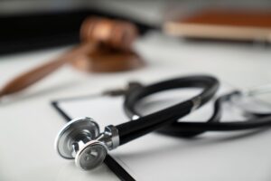 A stethoscope and a gavel on a medical negligence solicitors desk.