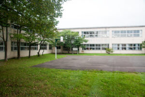 The partly grass-covered grounds of a school, which can be a common setting for historic sexual abuse compensation claims. 